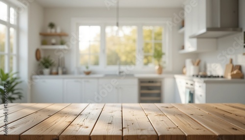 An empty wooden table with a bright white kitchen interior with a blurred background bathed in the early morning sun