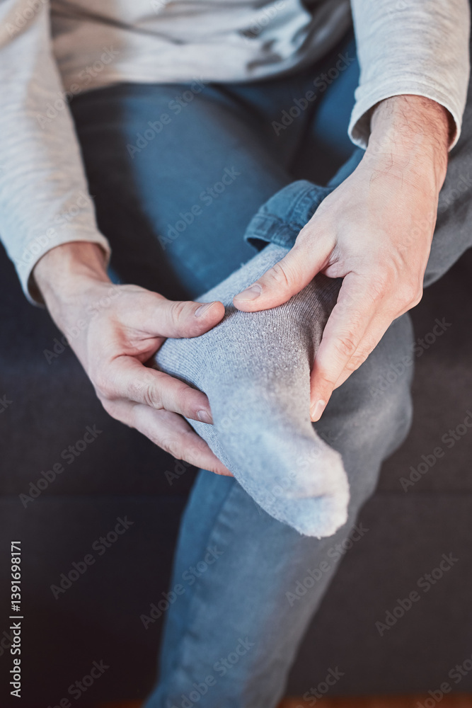 Man with ankle and foot pain at home.