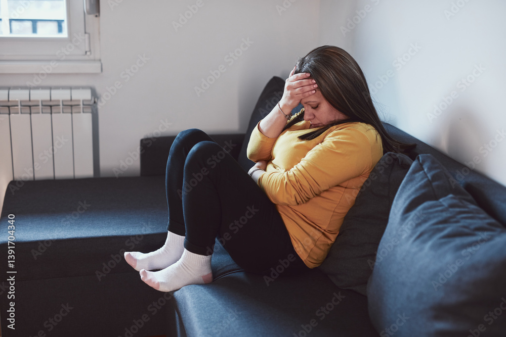 Woman with strong stomach ache, menstrual and digestive issues at home.