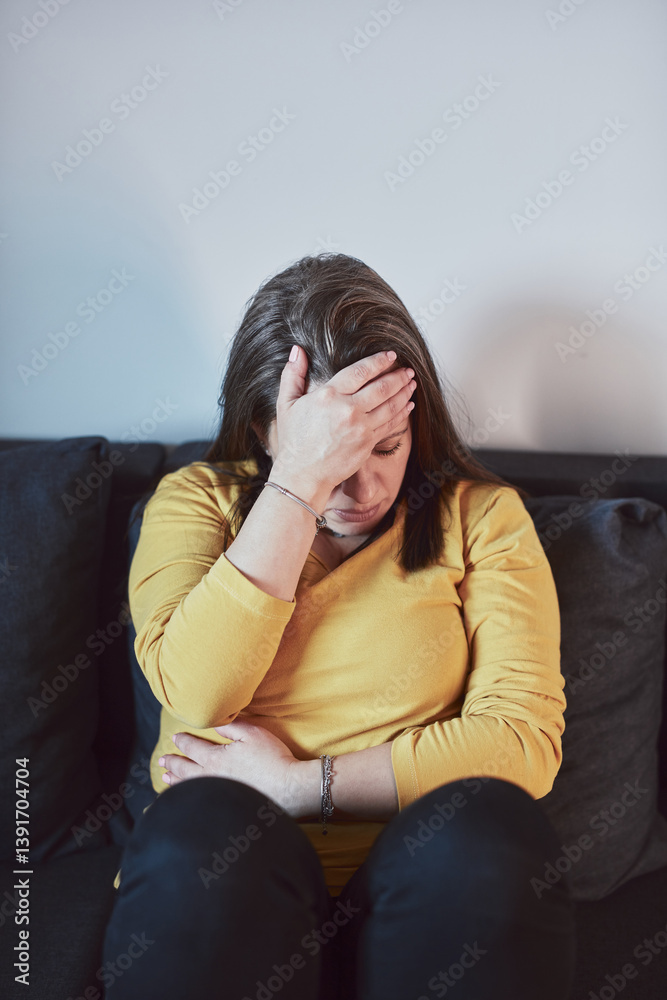 Woman with strong stomach ache, menstrual and digestive issues at home.