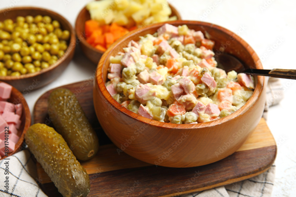 Bowl of tasty Olivier salad on light background, closeup Bowl of tasty Olivier salad on light background, closeup