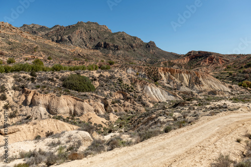 Beautiful scenery with winding gravel dirt road, Costa Blanca , Alicante, Spain - stock photo