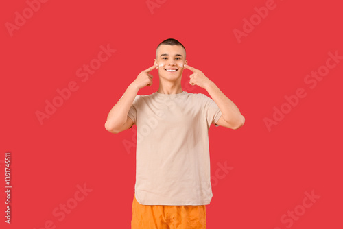 Happy young man pointing at...