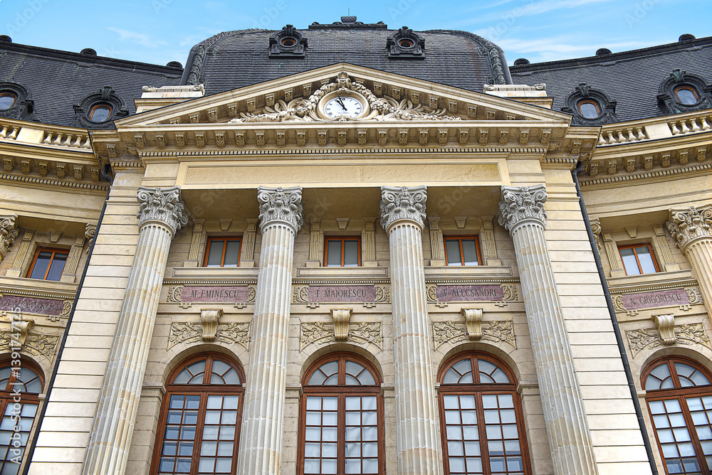 Fototapeta premium the Architecture Palace Facade Neoclassical, round windows, stone ornaments and a clock on the roof top