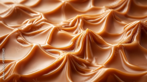 Close-up of rich, creamy caramel dessert with a textured surface resembling soft waves.