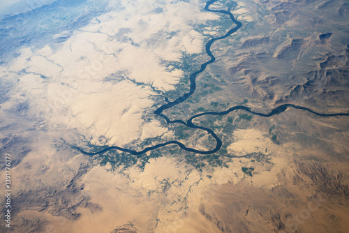 Euphrates river meandering through arid landscape, creating fertile oasis, aerial view