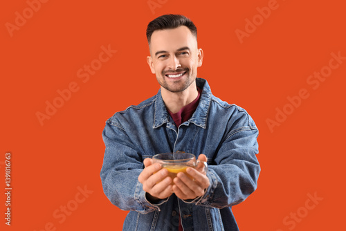 Handsome man with cup of le...