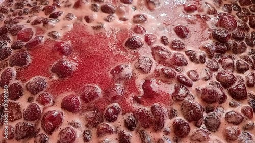 Close-up of the process of making strawberry jam