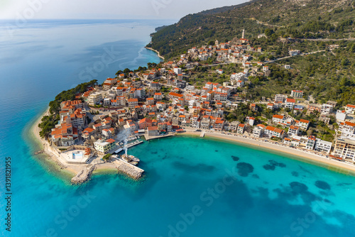 Fototapeta Naklejka Na Ścianę i Meble -  Makarska riviera. Aerial view of a small town Igrane on the Adriatic coastline. Residential buildings and a beach with clear turquoise water