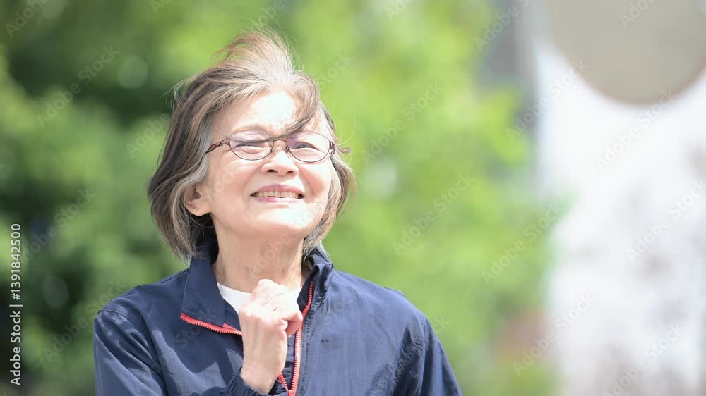 Slow motion video of an elderly senior woman walking or running in a fresh green park or other exercise.
