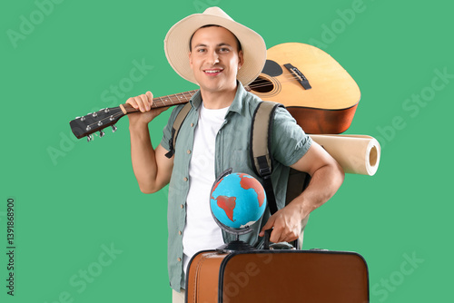 Male tourist carrying guita...