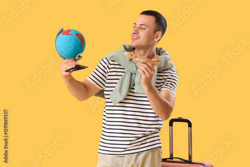 Male tourist with globe and...