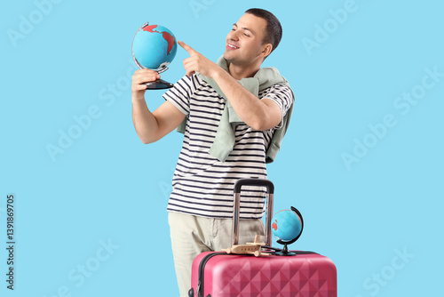 Male tourist with globe and...
