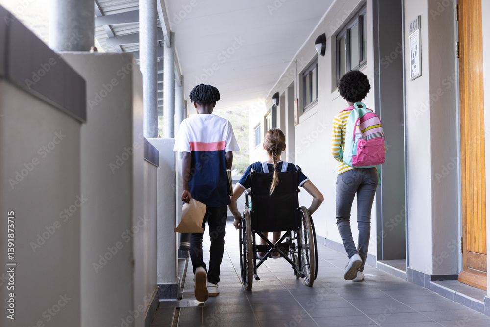 Fototapeta premium Walking in school hallway, diverse students with backpacks and wheelchair, heading to class