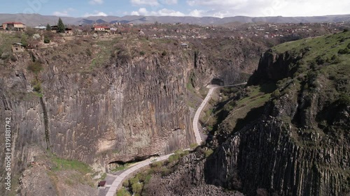 Aerial view of a trail cutting its way through rugged mountainous landscape of Garni Gorge