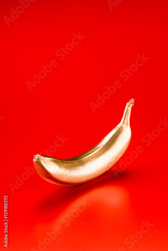 Golden Banana on Red Background