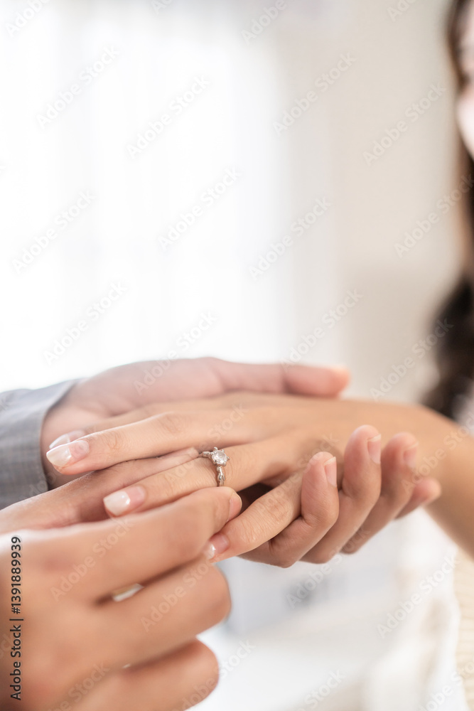 Close up of romantic groom puts wedding diamond ring on bride's finger. Close up of romantic groom puts wedding diamond ring on bride's finger.