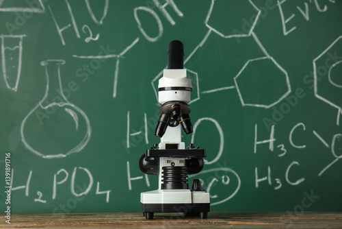 Modern microscope on wooden...