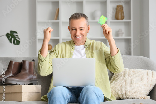 Happy mature man with lapto...
