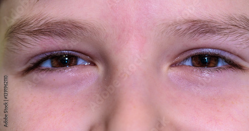 cheerful boy eyes looking at camera close up part of face