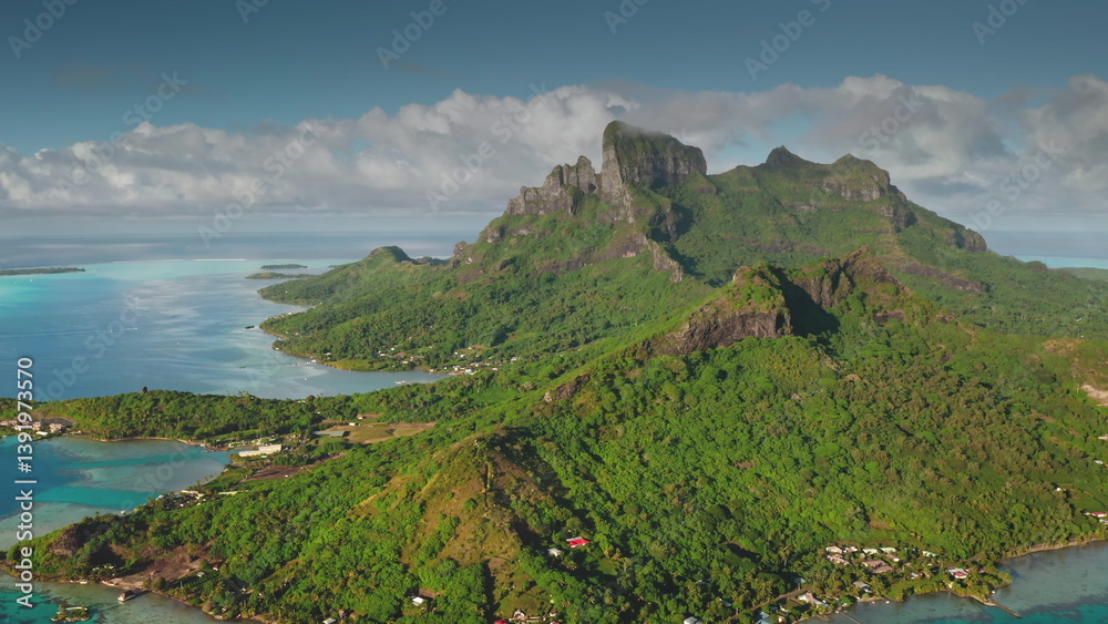 Capturing breathtaking aerial views of Bora Bora, featuring iconic mount Otemanu, lush green slopes, and crystal-clear turquoise lagoon waters