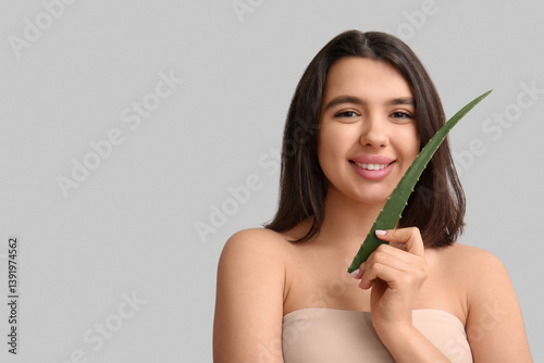 Happy young woman with aloe...