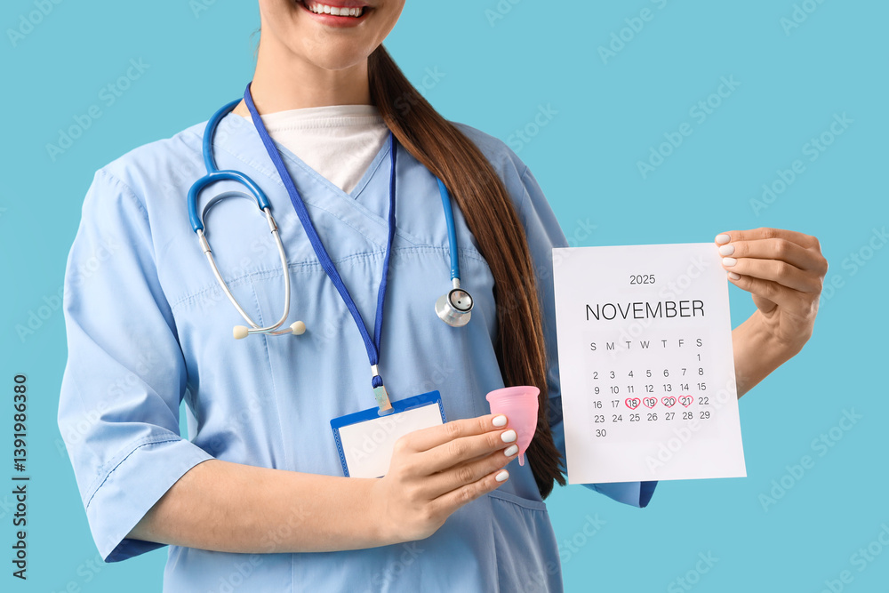 Female doctor with menstrual calendar and cup on blue background, closeup Female doctor with menstrual calendar and cup on blue background, closeup