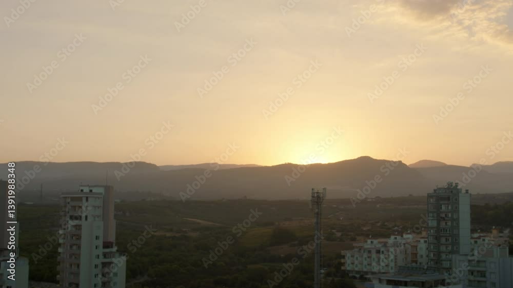 custom made wallpaper toronto digitalBeautiful sunset, the sun sets down behind the mountain, sun rays in the haze, cityscape on the background of the mountains