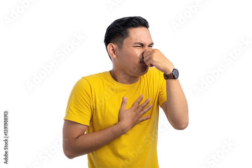 Konstfotografi Handsome Asian man pinching his nose with fingers, smelling something smelly and