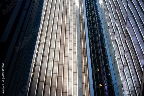Dynamic contrast between light and shadow on skyscrapers, expressing scale, progress and financial power.