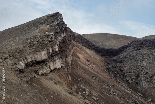 Obraz na płótnie Severe mountain landscape. View of the rocky peak of the volcano. Travel and hiking on the Kamchatka Peninsula. Nature of Siberia and the Russian Far East. Gorely volcano, Kamchatka Territory, Russia. w salonie