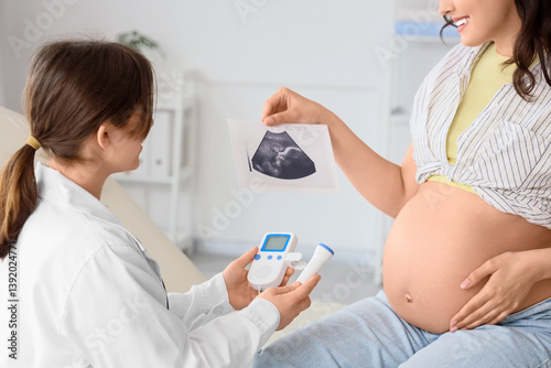 Young pregnant woman and do...
