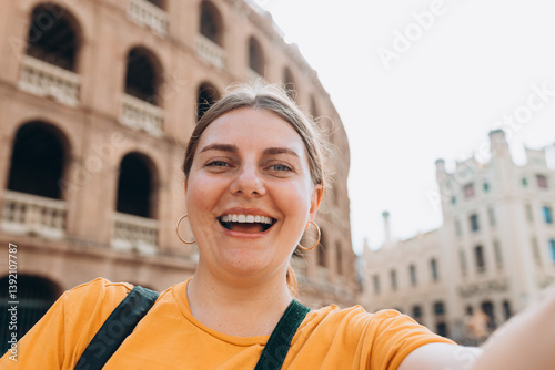 Obraz na płótnie Beautiful 30s female walking in Valencia. Young traveling woman taking selfie outdoors. Concept of travel, tourism and vacation in city. High quality photo w salonie