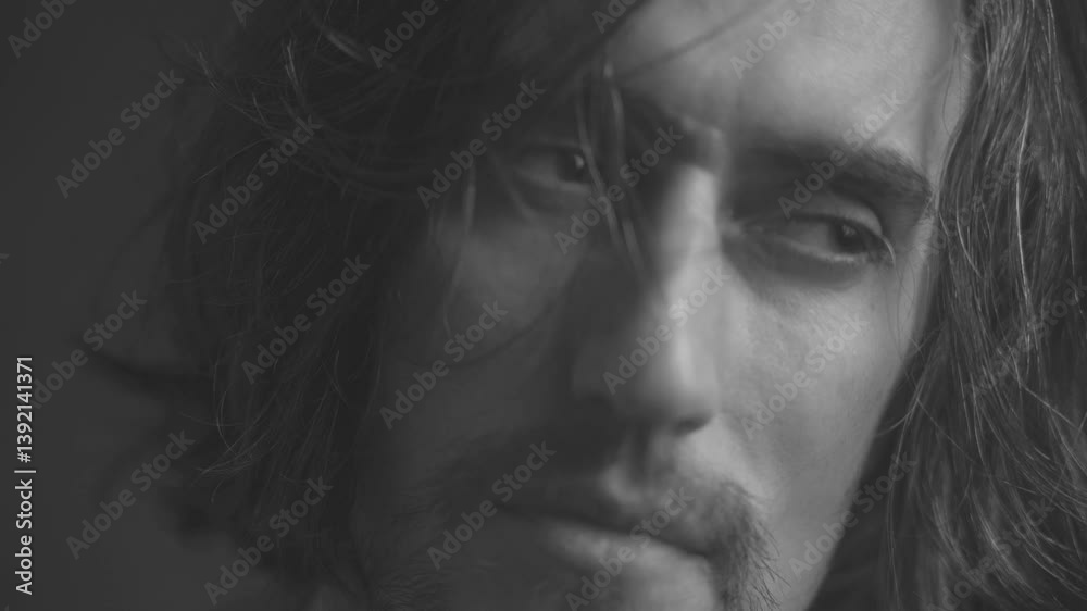 Introspective Man with Tousled Hair and Subtle Beard in Black and White Close-Ups Introspective Man with Tousled Hair and Subtle Beard in Black and White Close-Ups