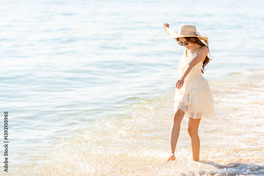 Happy Asian woman travel nature the sea on summer beach holiday vacation. Portrait of Attractive girl in white dress and sun hat enjoy outdoor lifestyle walking on tropical island beach in sunny day. Happy Asian woman travel nature the sea on summer beach holiday vacation. Portrait of Attractive girl in white dress and sun hat enjoy outdoor lifestyle walking on tropical island beach in sunny day.