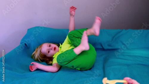 Child enjoys healthy snack while sitting on couch in bright room during afternoon