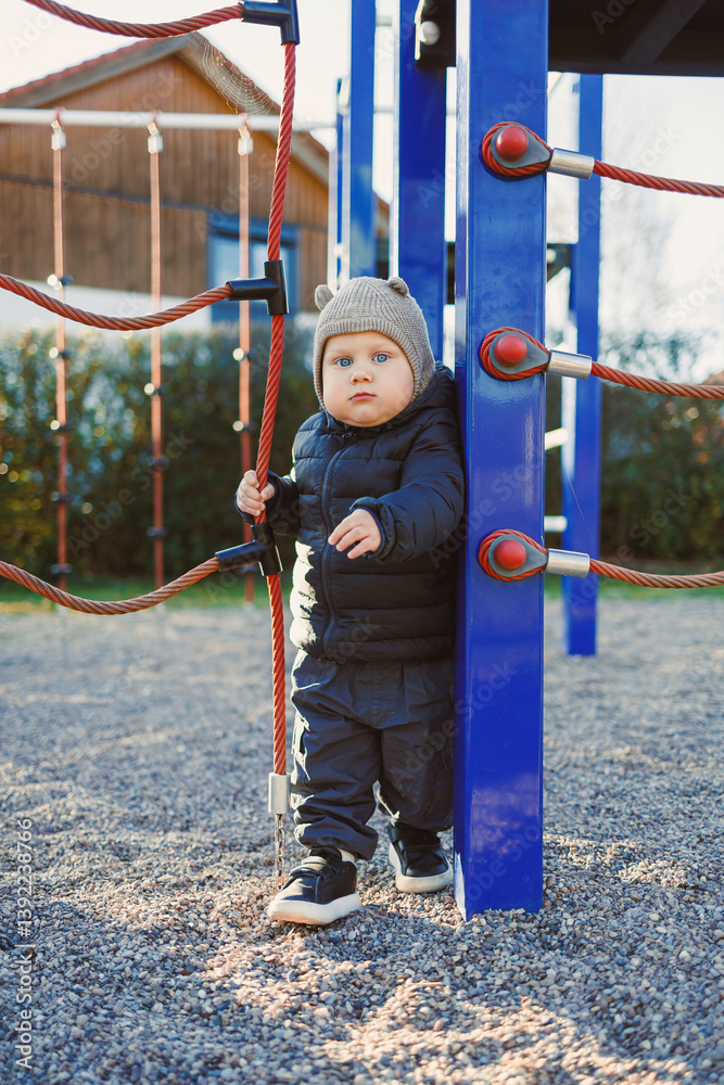 Happy toddler boy on a walk on the playground. Child development, healthy lifestyle of the child. Boy outdoors on an autumn walk.