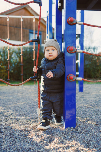 Obraz na płótnie Happy toddler boy on a walk on the playground. Child development, healthy lifestyle of the child. Boy outdoors on an autumn walk. w salonie