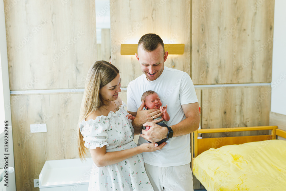Joyful new parents celebrate the arrival of their newborn baby in a bright and welcoming hospital room, filled with happiness, love, and warmth as they begin their journey into parenthood together
