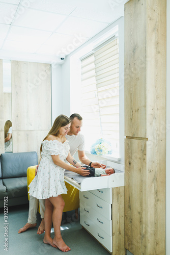Obraz na płótnie A loving couple is seen together in a beautifully modern room, engaging in a tender and heartfelt moment while excitedly preparing for the arrival of their new baby, filled with joy and anticipation w salonie