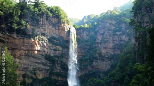 Tall Waterfall Cascading Down Lush Green Cliffs