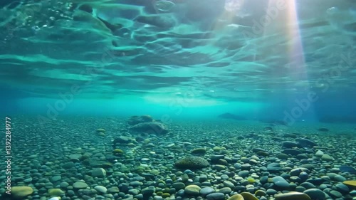 Crystal Clear Alpine Lake with Underwater View of Pebbles and Majestic Mountains