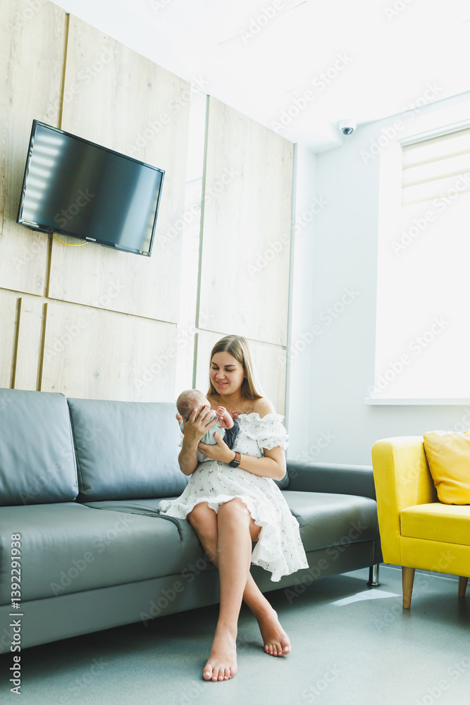 A heartwarming moment of bonding between a mother and her baby is captured beautifully within a modern interior setting, showcasing their affectionate relationship, filled with love and joy