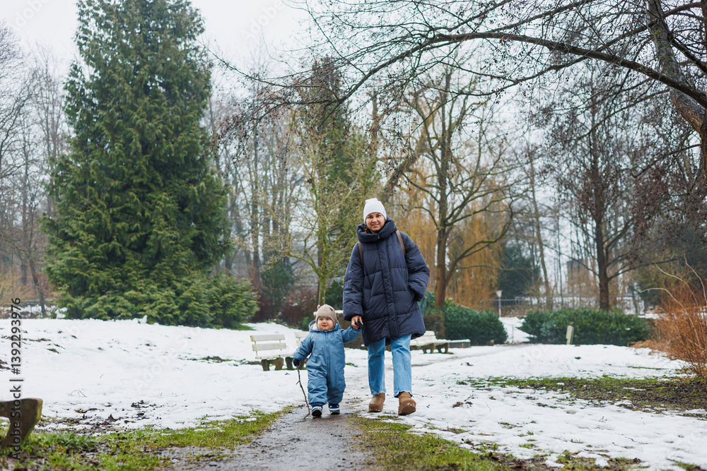 Enjoying a delightful family winter walk especially capturing the immense joy that parenting brings while exploring a beautiful snowy landscape with a precious child at your side