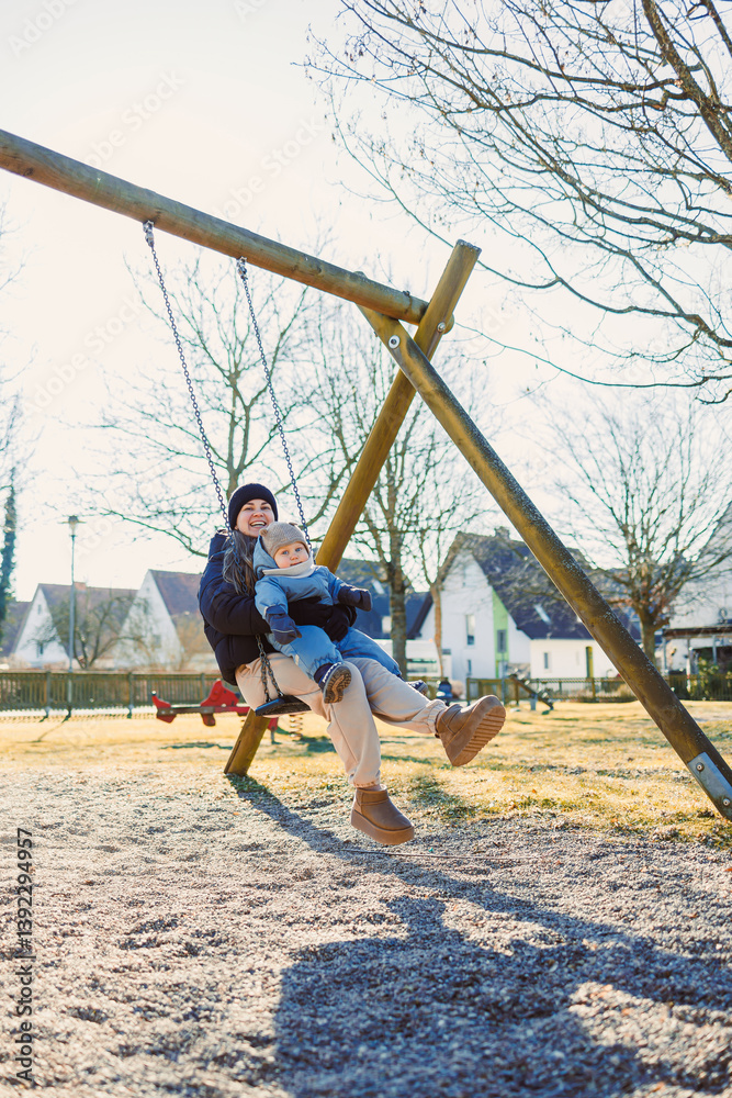 Joyful Moments on a Swing A Parent and Child With Gleeful Laughter Cozily Enjoy Their Time Together at the Park, Cherishing Every Happy Memory Made Under the Bright Sunshine and Clear Blue Sky