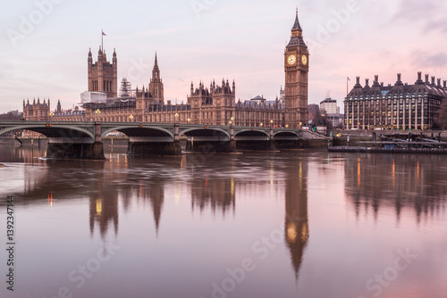 Houses of Parliament, Big Ben and Westminster bridge reflected in the River Thames at sunrise, London, England, UK