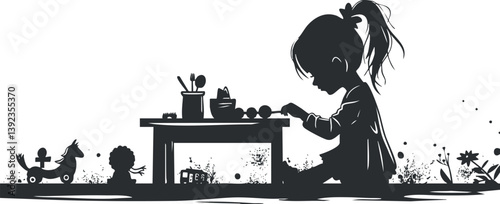 Silhouette of a young girl playing with toys and drawing at a table in black and white.