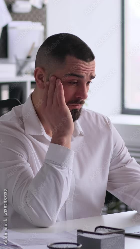 Overload middle aged male Caucasian freelancer suffering from headache or migraine while working in the office. Concept of a tiredness and burnout. Vertical video. Overload middle aged male Caucasian freelancer suffering from headache or migraine while working in the office. Concept of a tiredness and burnout. Vertical video.