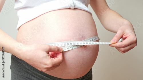 belly size during pregnancy, a woman measures her belly circumference in the ninth month of pregnancy