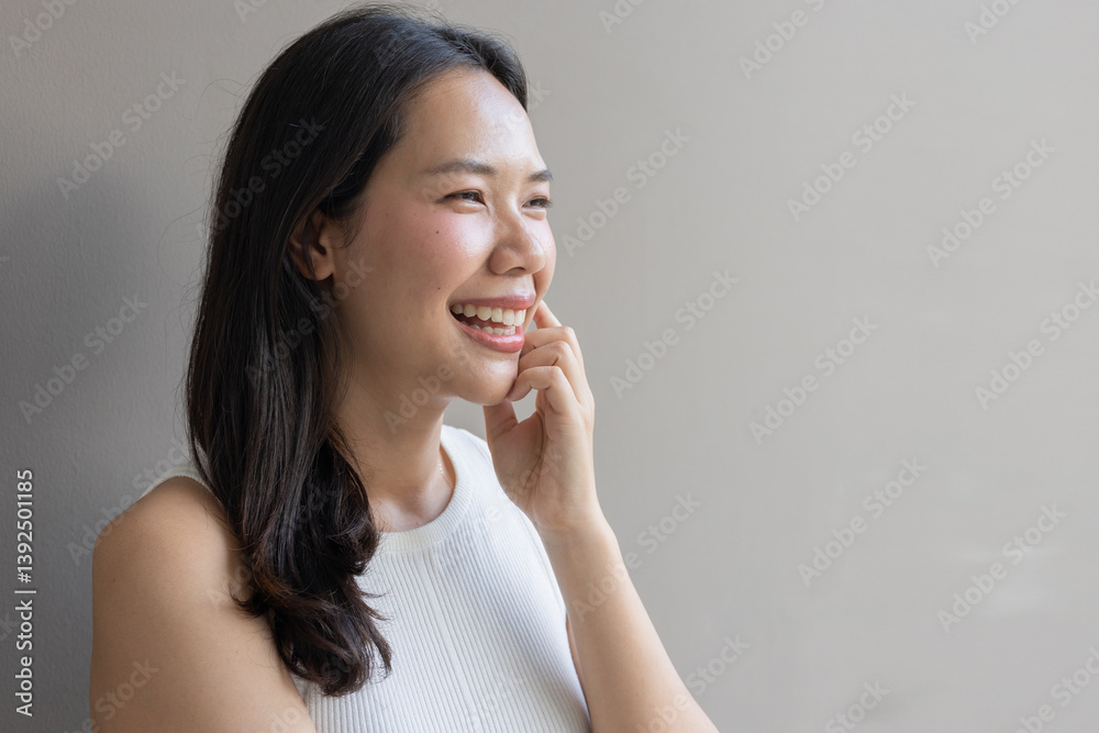 close up beautiful asian woman smile and beauty teeth and happy feeling on gray color background for veneer and invisalign treatment concept close up beautiful asian woman smile and beauty teeth and happy feeling on gray color background for veneer and invisalign treatment concept